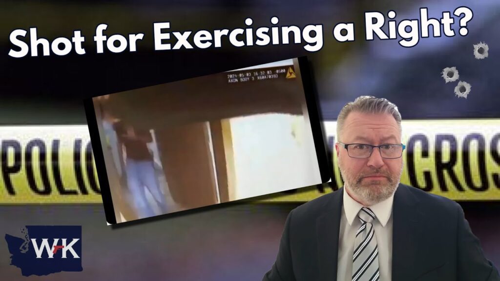 A man in a suit stands in the foreground with a skeptical expression. Behind him, a blurred police line and a small, unclear image of an indoor scene are visible. The text reads "Shot for Exercising a Right?" along the top.