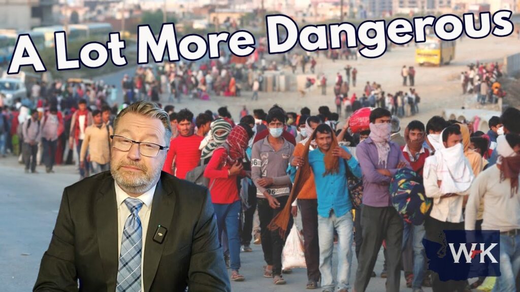 A man in a suit sits with a serious expression in front of a background featuring a long line of people, some wearing masks and covering their heads. The text "A Lot More Dangerous" is displayed at the top.