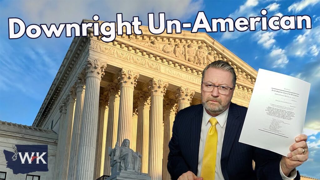 A man in a suit holds a document in front of a large building resembling the U.S. Supreme Court. The sky is partly cloudy. Large text reads "Downright Un-American." There is a logo with "WY" in the corner.