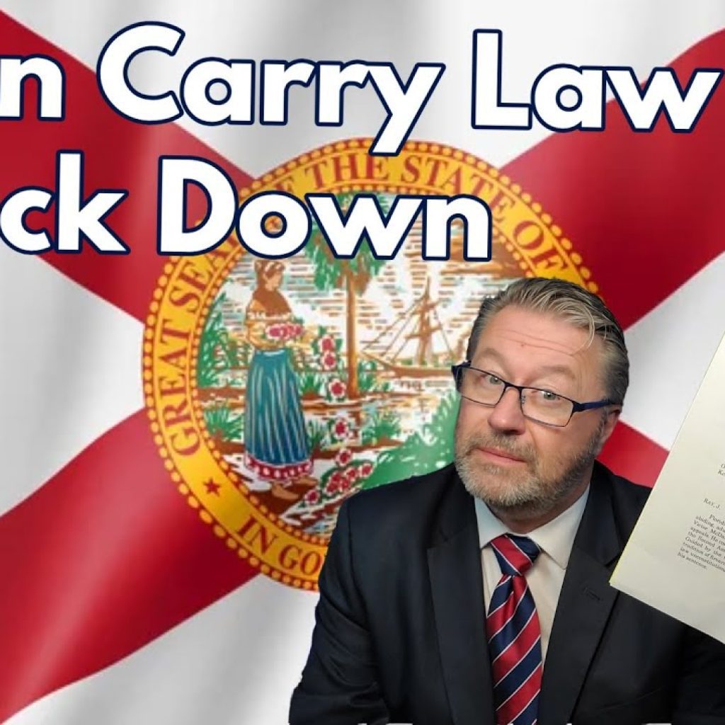 A man in a suit holds up a legal document in front of a Florida state flag. Text on the image reads "Open Carry Law Struck Down." The WK logo appears in the bottom left corner.