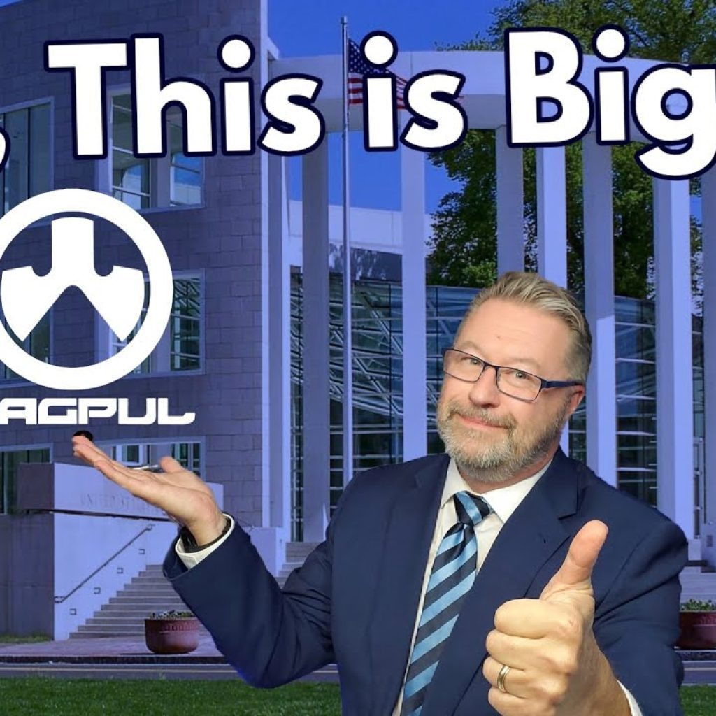 A man in a suit gives a thumbs up and gestures to the Magpul logo, with the text “OK, This is Big” above him. He stands in front of a modern building with columns and glass windows.